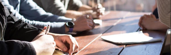 Hands on desk at meeting